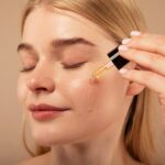 close-up-woman-applying-serum_23-2149182127