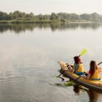 long-shot-women-rowing-kayak_23-2148683927