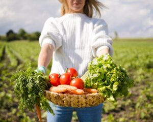 woman-holding-basket-full-vegetables-front-her_23-2148580020