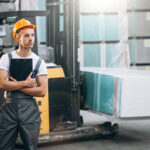 Young man working at a warehouse with boxes