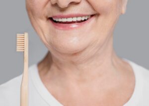 close-up-woman-holding-toothbrush_23-2148803477